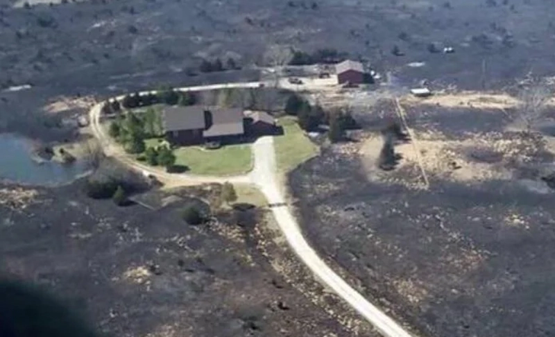 Misleading: This image shows a house that was saved from a forest fire because the owner left the sprinklers running before evacuating.