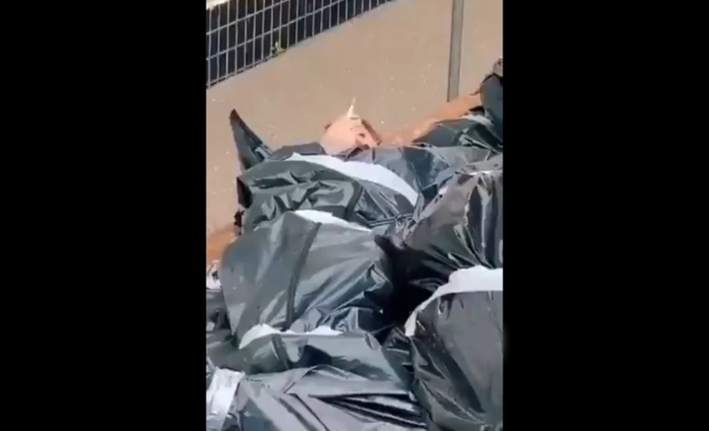 False: In a video clip from Ukraine, a man in a body bag can be seen smoking a cigarette.