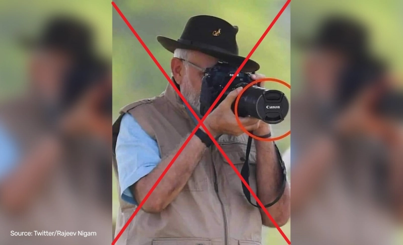 False: PM Narendra Modi tried to click a picture without removing the camera lens cap.